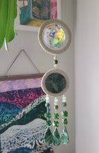 Load image into Gallery viewer, Maori inspired Suncatcher with faux Paua mu and stone accents. Green faceted beads and a colorful central design, against a neutral background.
